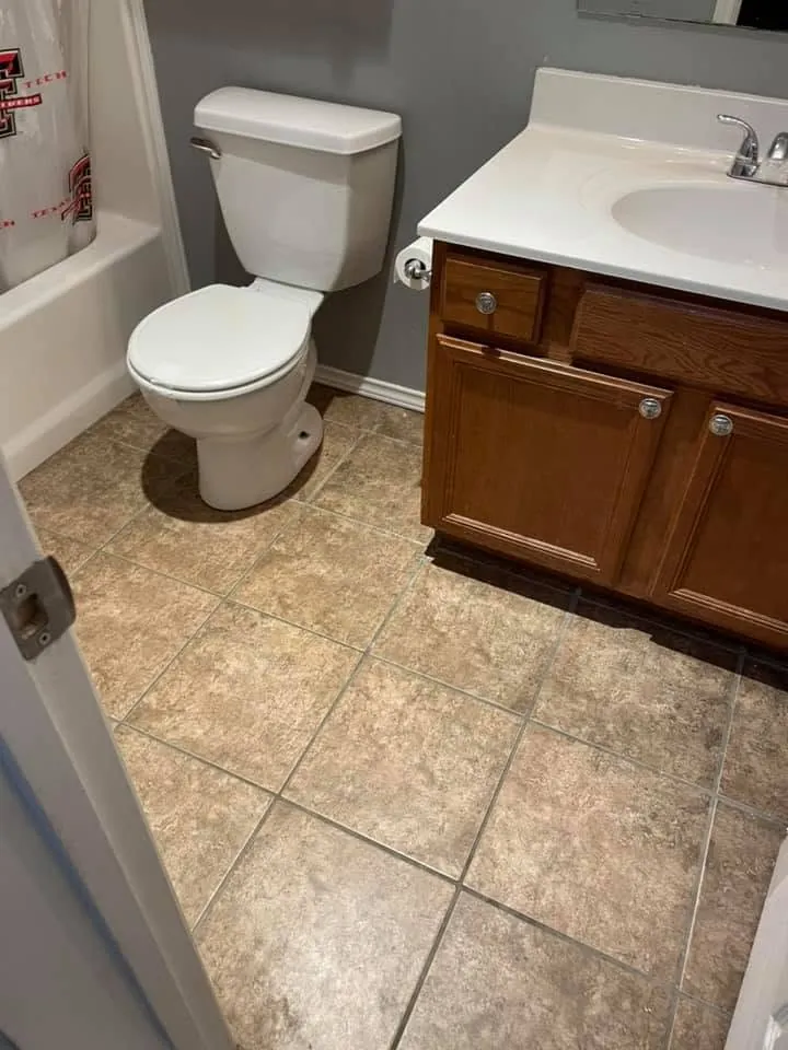 Bathroom with a new tile floor, vanity and toilet