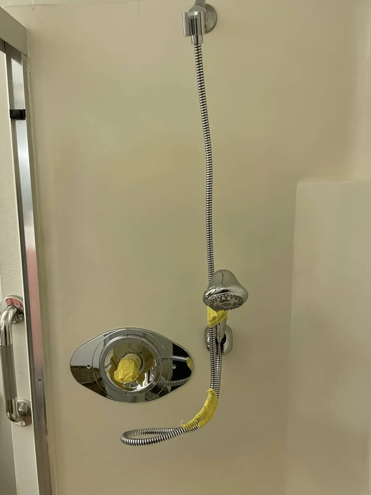 Shower enclosure with the fixtures out during a bathroom renovation